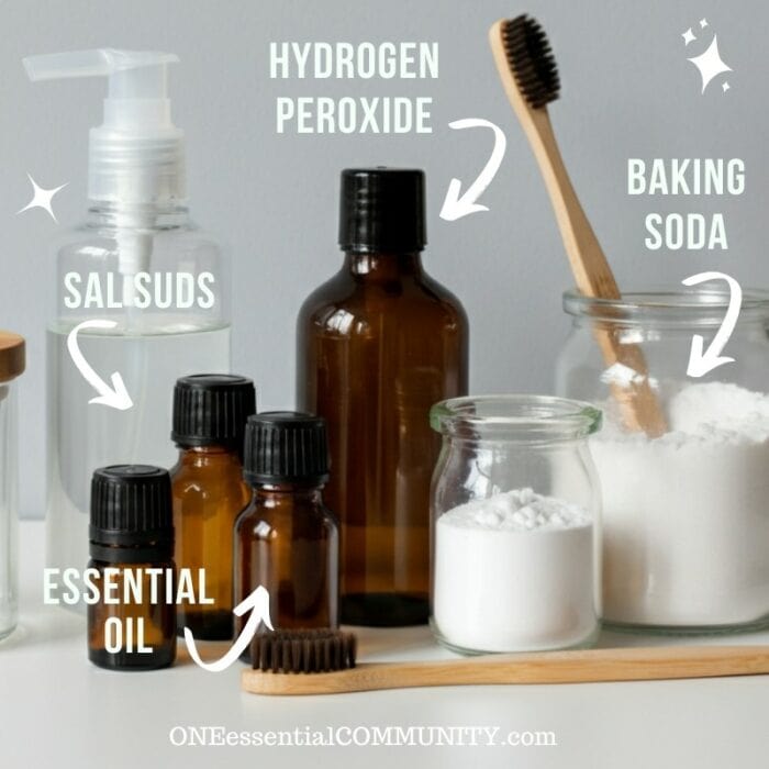 supplies for making homemade magic cleaning paste-- essential oil, Sal Suds, hydrogen peroxide, and baking soda