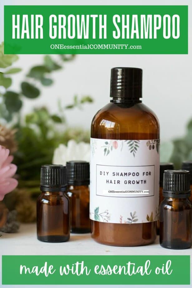 Hair Growth Shampoo by oneessentialcommunity.com made with essential oil -- amber plastic shampoo bottle with a few 15ml amber essential oil bottles and greenery/flowers in background