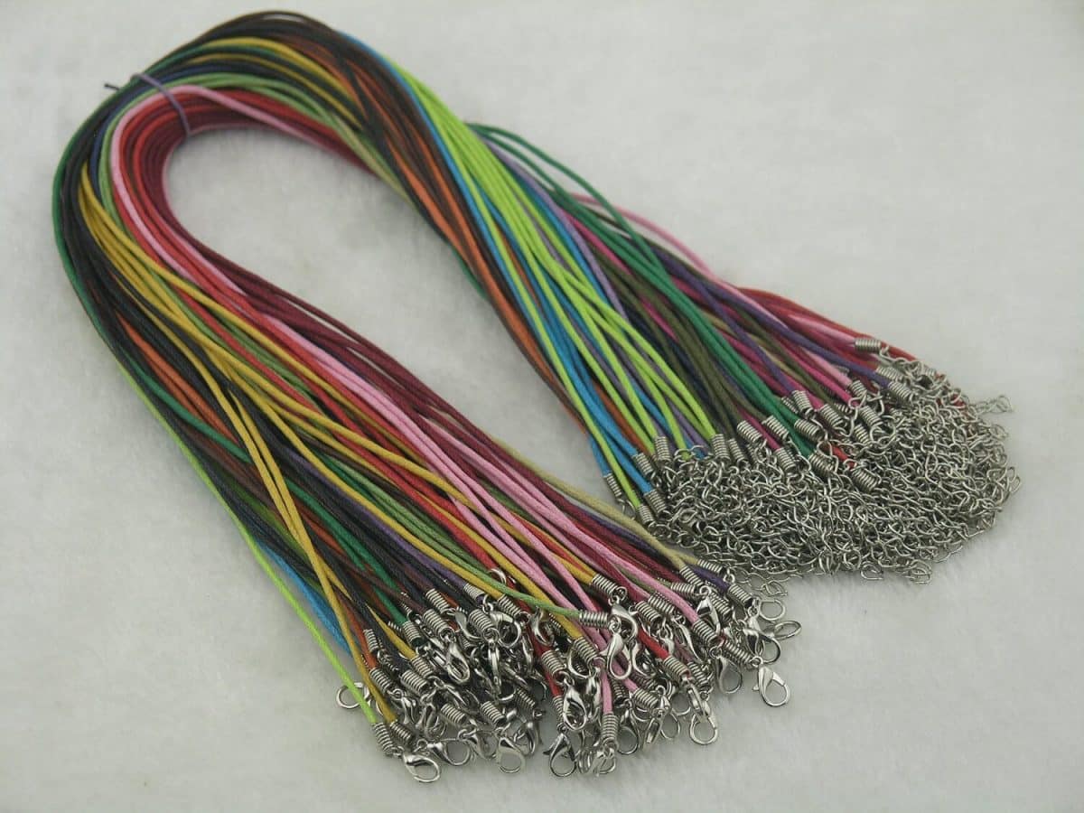 a bundle of cotton wax necklaces in bright colors from pink to blue, green, orange, and brown