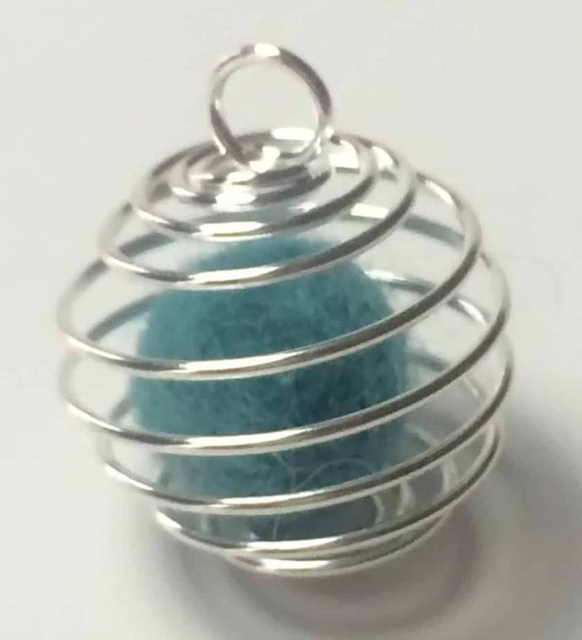 small cyan wool ball inside of silver wire cage pendant
