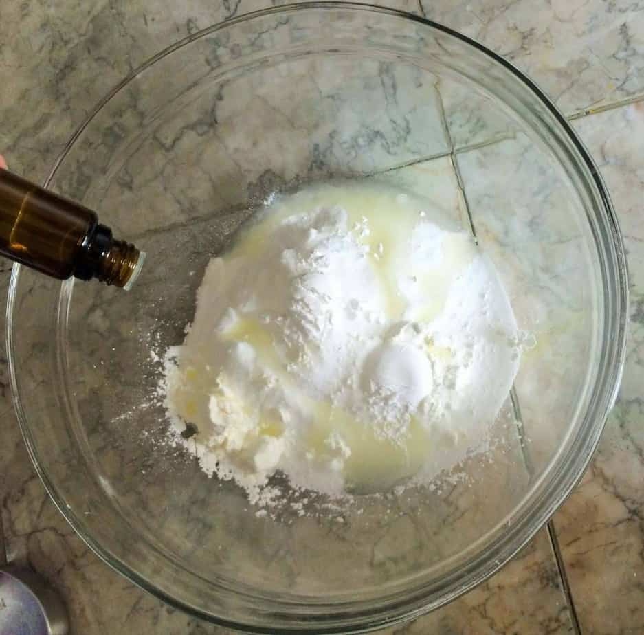 adding essential oil to bath bomb mixture