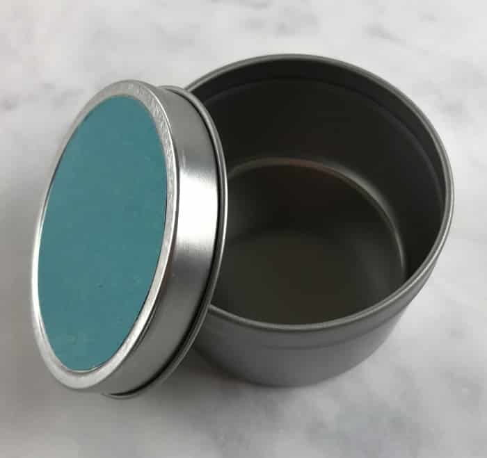 scrapbbok paper attached to container's lid with modge podge