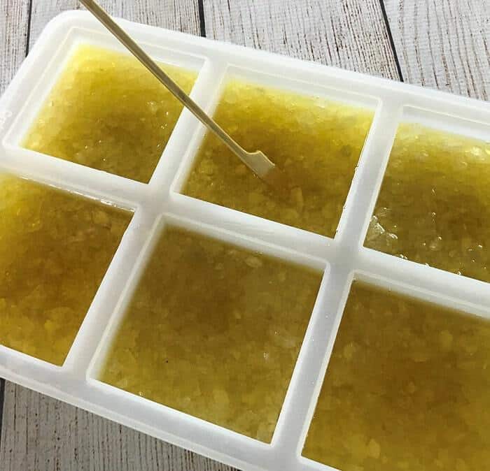 stirring rock salt with melted butters and essential oil