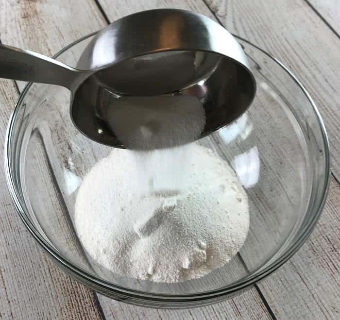 Easy-to-make natural dishwasher detergent recipe-- for clean, sparkling dishes without using harsh, toxic chemicals. {made with essential oils} DIY essential oil recipe for dishwasher detergent. #essentialoils #essentialoilrecipes #essentialoilcleaning #naturalDIY #naturalcleaning #homemadedishwasherdetergent #DIYcleaning #essentialoilDIY #essentialoilsforkitchen #easyDIY