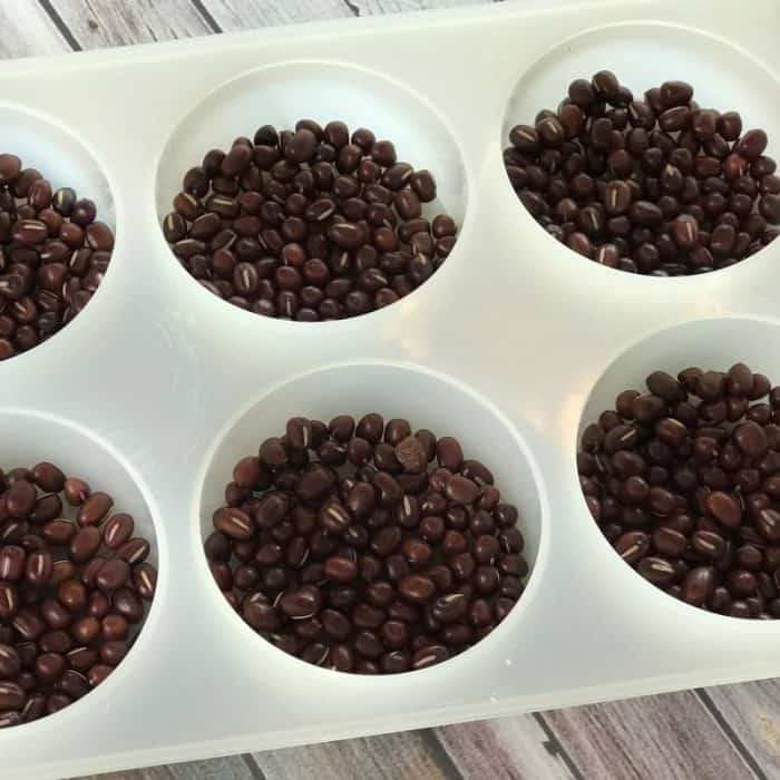 Lush copycat recipe for Wiccy Magic Muscles massage lotion bars - combination of cinnamon and peppermint essential oils provides warm, tingly sensation that soothes sore, achy muscles. Adzuki beans apply light pressure and feel like tiny little fingertips giving you a wonderful relaxing massage. #Lushcopycat #essentialoilrecipes #essentialoilDIY #essentialoiluses #lotionbars #essentialoils #DIYbeauty