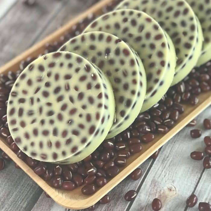 Lush copycat recipe for Wiccy Magic Muscles massage lotion bars - combination of cinnamon and peppermint essential oils provides warm, tingly sensation that soothes sore, achy muscles. Adzuki beans apply light pressure and feel like tiny little fingertips giving you a wonderful relaxing massage. #Lushcopycat #essentialoilrecipes #essentialoilDIY #essentialoiluses #lotionbars #essentialoils #DIYbeauty