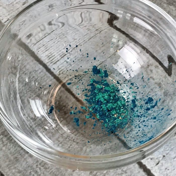 Couple of pinches of mica in clear small bowel for Copycat Lush Ocean Salt scrub recipe made with essential oils