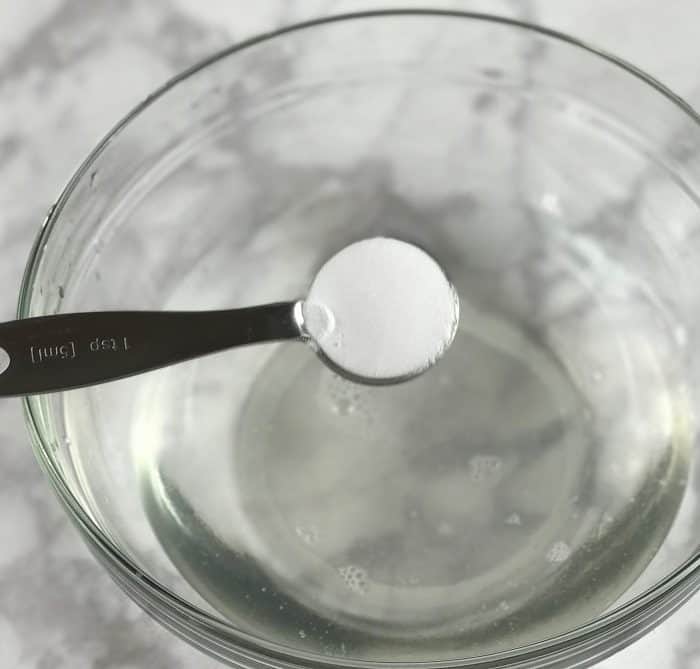adding baking soda to mixing bowl