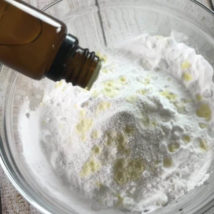 adding essential oil to baking soda and borax mixture