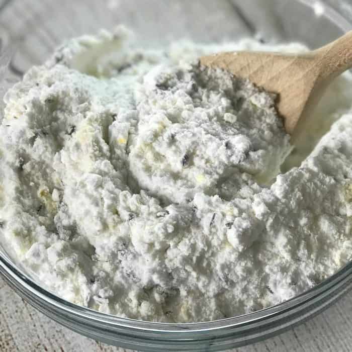 mixing up homemade scouring powder with wooden spoon