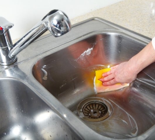 using homemade scouring powder with essential oils to clean stainless steel sink