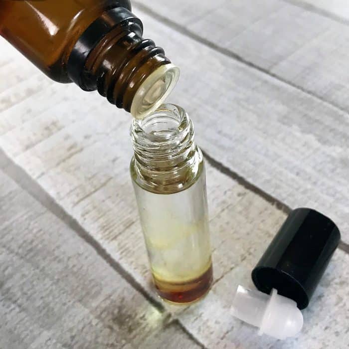 adding essential oils to roller bottle for DIY anxiety blend