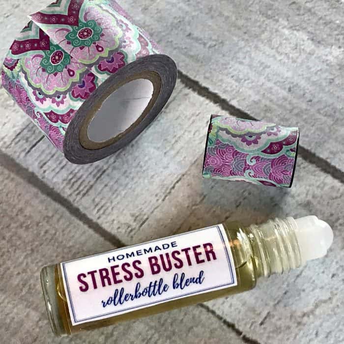 adding washi tape to roller bottle cap for decoration - homemade stress buster roller bottle blend
