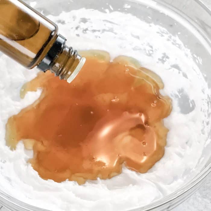 essential oils being added to honey and coconut oil for the home cough remedy