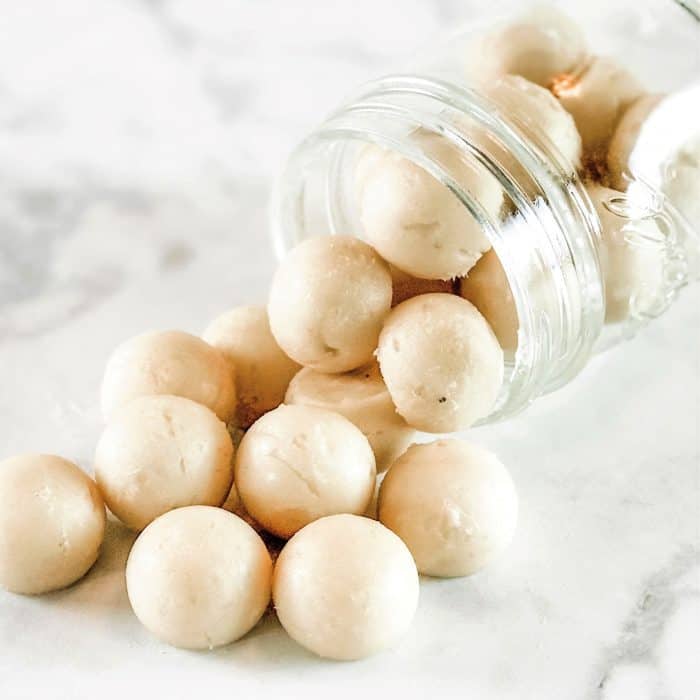 natural cough drops spilling out of glass jar