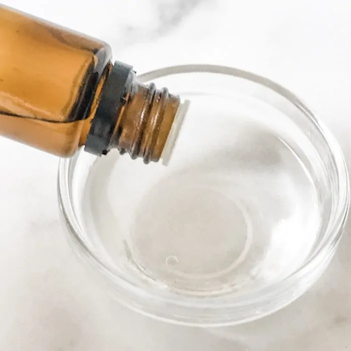 essential oil bring poured into small glass bowl