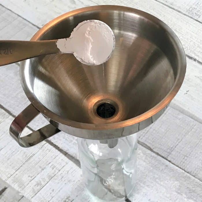 calcium carbonate being added to homemade dry shampoo spray