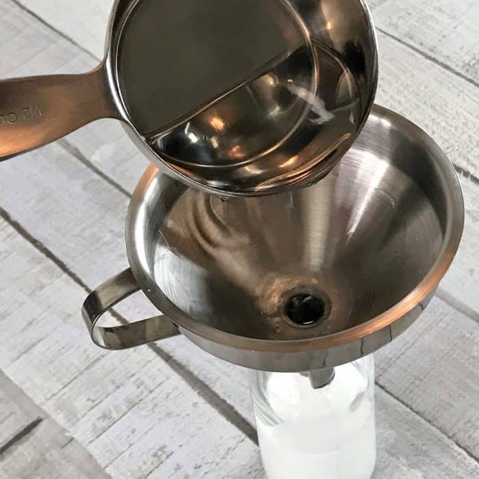 vodka being added to homemade dry shampoo spray