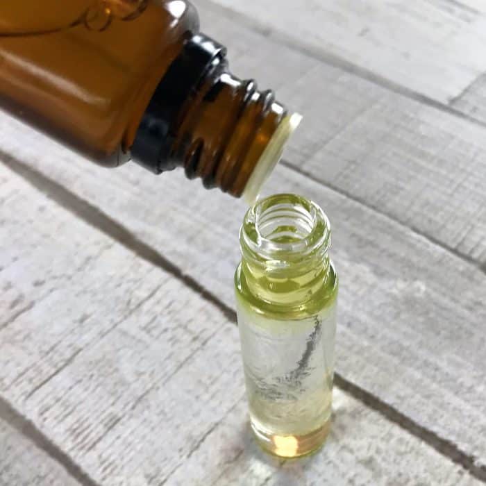 adding essential oils to roller bottle for sore feet