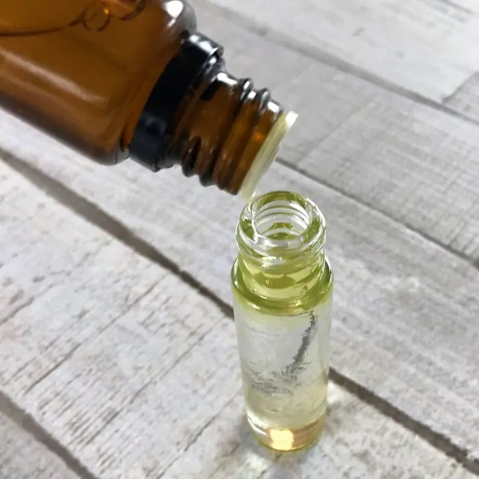 adding essential oils to roller bottle for sore feet
