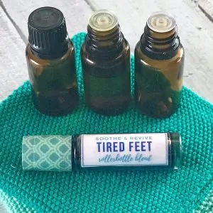 3 essential oil bottles and tired feet roller bottle