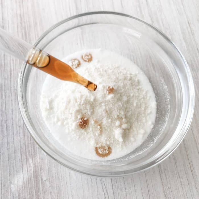 adding vanilla extract to sugar and white chocolate