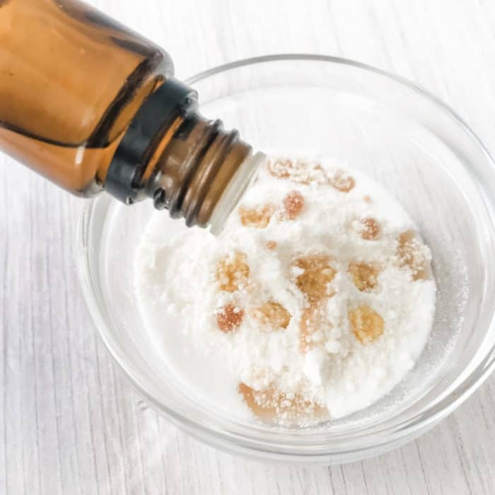 adding tangerine essential oil to sugar, white chocolate, and vanilla extract