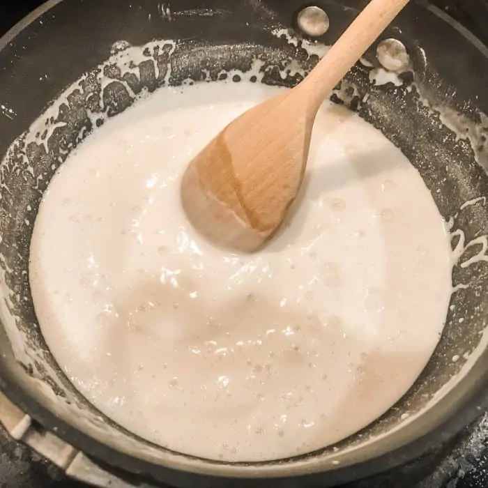 heating and stirring baking soda, cornstarch, and water with wooden spoon