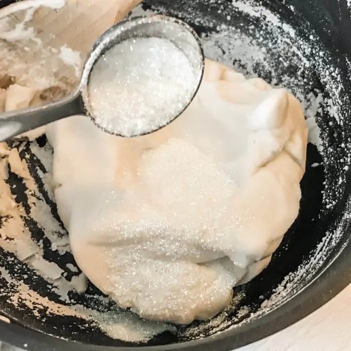 adding glitter to thickened salt dough mixture of baking soda, cornstarch, water