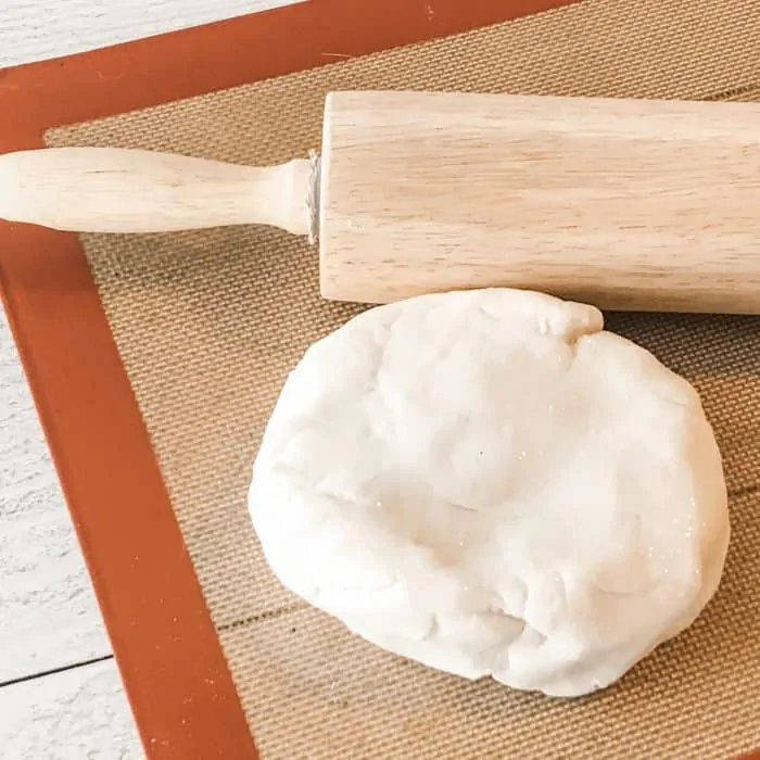 rolled out salt dough on silpat with rolling pin