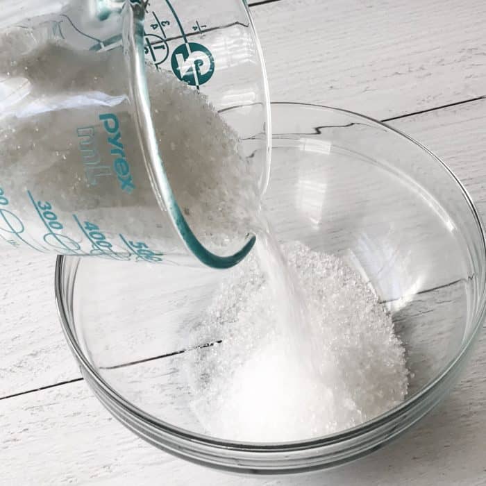 pouring Epsom salt into glass bowl