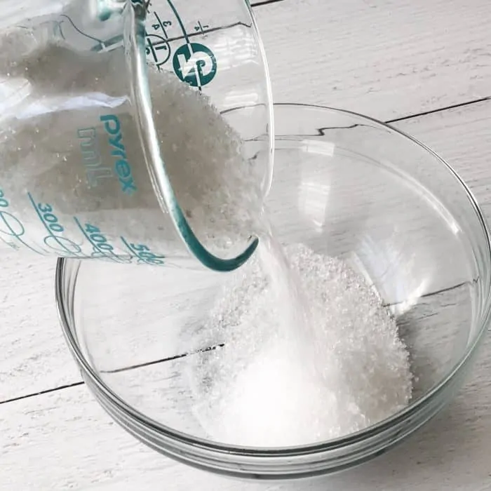 pouring Epsom salt into glass bowl