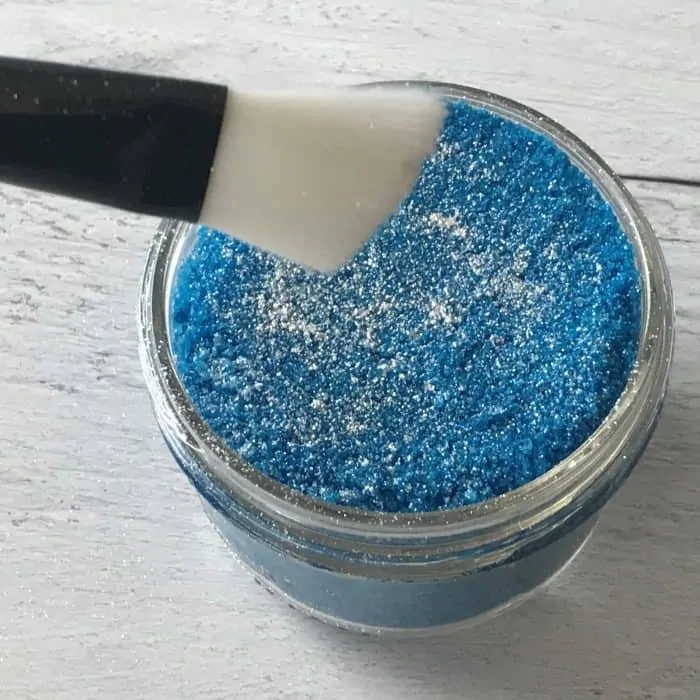 flicking silver mica with brush to the top of the Silent Night Bath Salts mixture