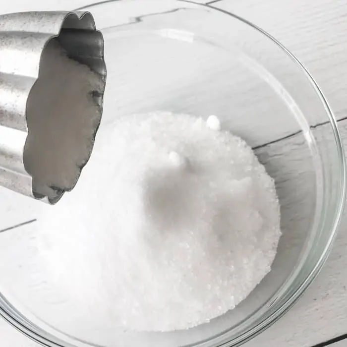 adding sea salt to Epsom salt in glass bowl