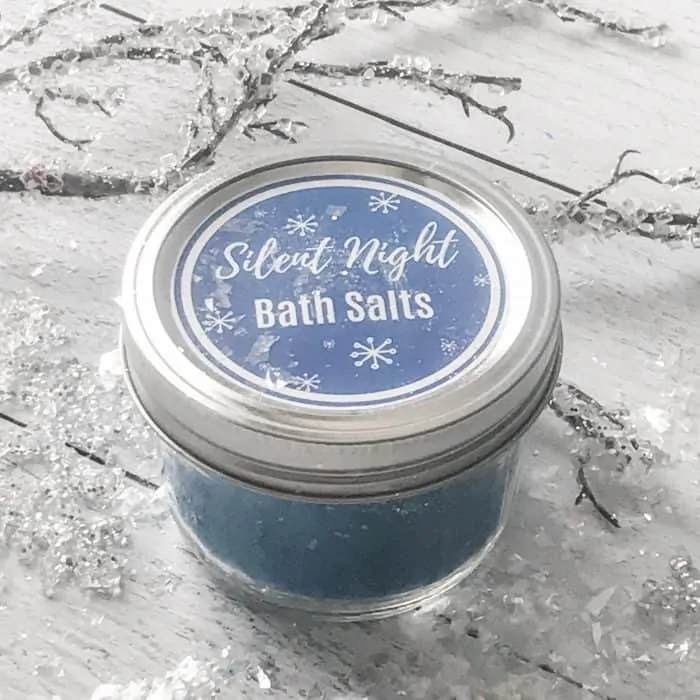 Silent Night Bath Salts in jar with custom label surrounded by snow and winter decorative elements