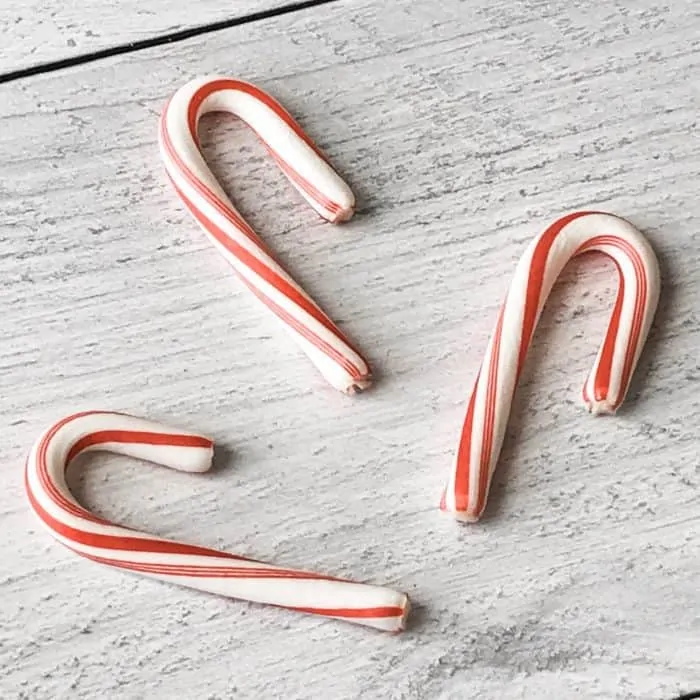 three candy canes ready for use in peppermint candy cane lip scrub with essential oils