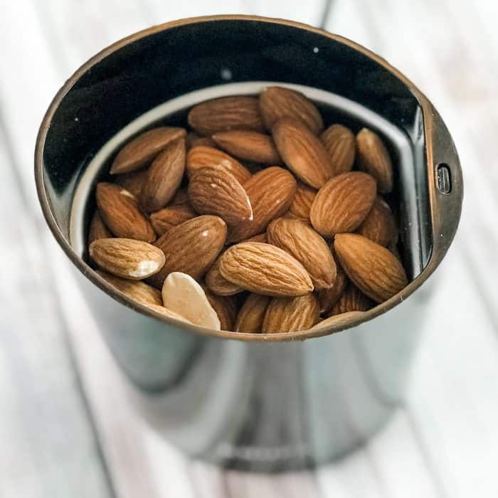 almonds, rice, and beans in metal jar, ready to grind into Lush Buffy Bar ingredient