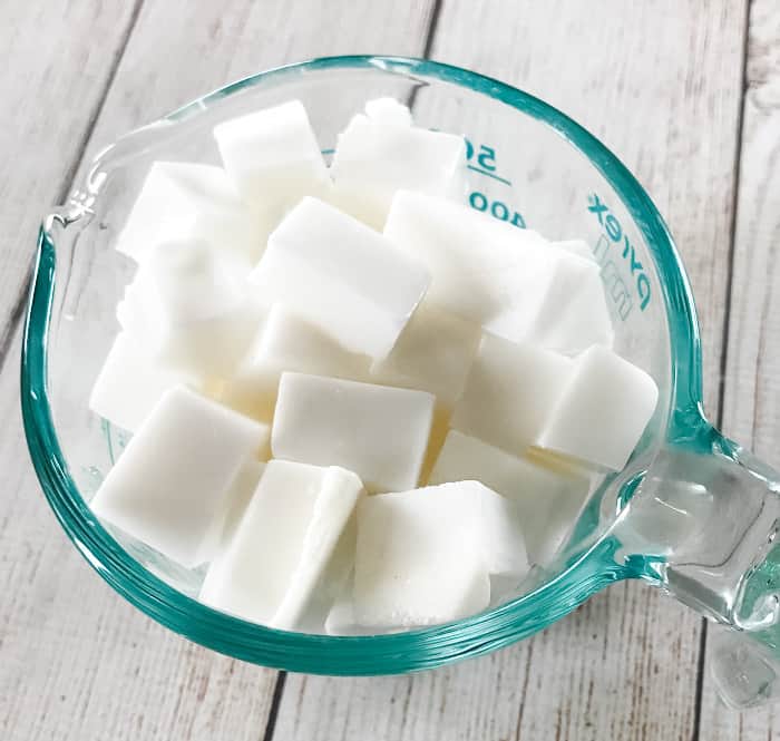 cubes of goat's milk melt & pour soap in glass measuring cup ingredient for DIY clay facial soap with essential oil One Essential Community