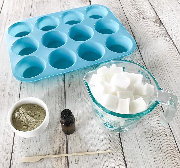 DIY clay facial soap ingredients and supplies, goat's milk melt & pour soap, bentonite clay, essential oil, silicone mold, wooden skewer
