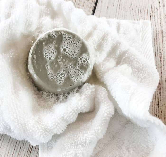 wet clay facial soap bar on wet towel