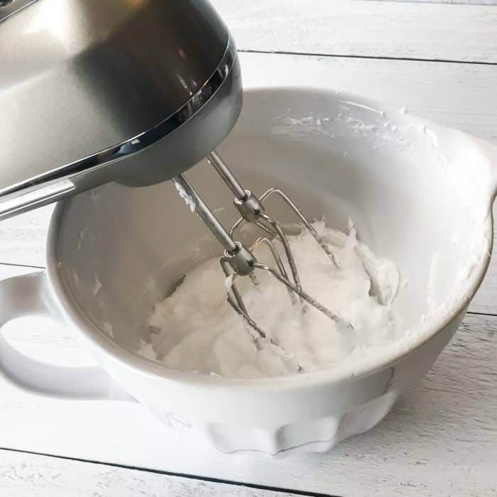 essential oil joint pain cream treat achy hands, shoulders, knees with Joyful Joints cream whipping coconut oil into cream with electric hand mixer