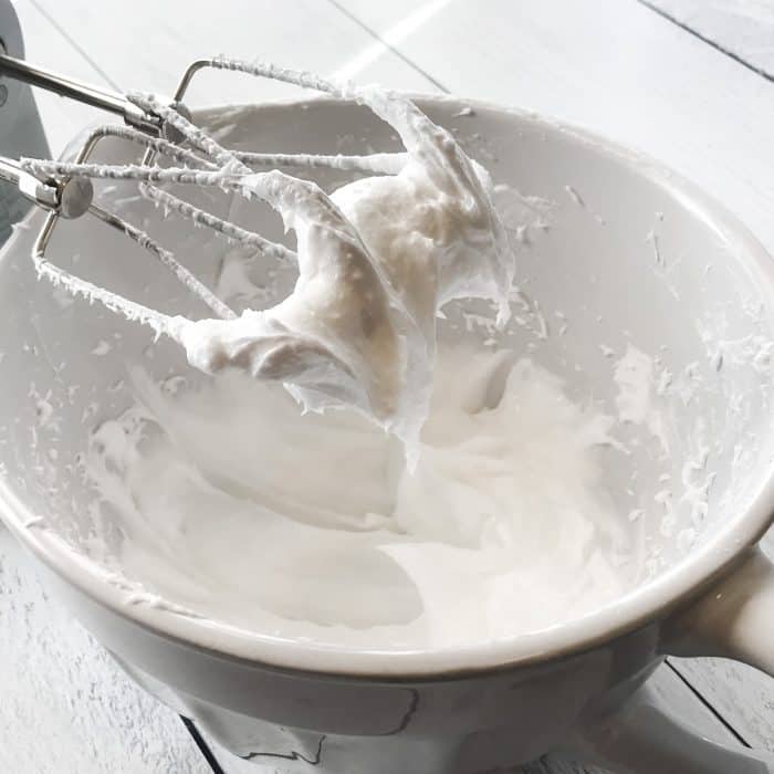 essential oil joint pain cream treat achy hands, shoulders, knees with Joyful Joints cream closeup of cream on electric mixer beaters to show smooth texture of coconut oil and essential oil whipped into cream