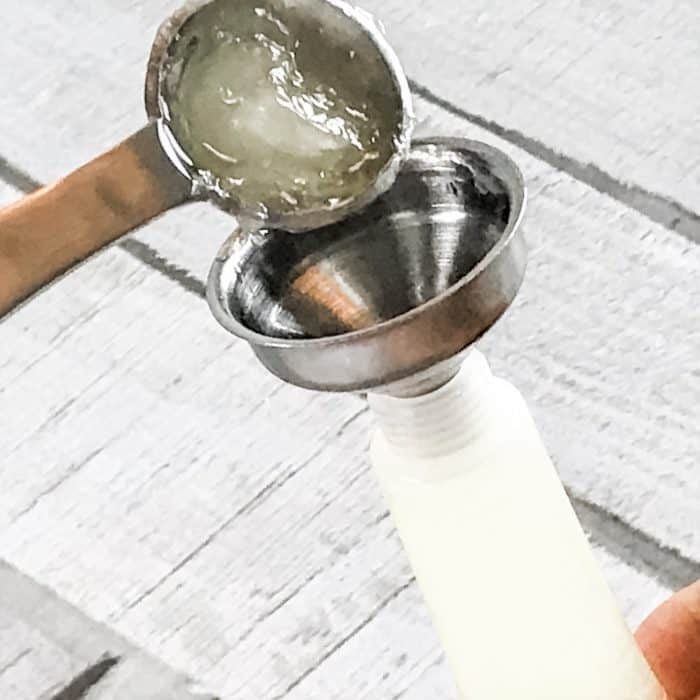 using funnel to pour acne gel into tube tom make all natural acne treatment gel with essential oils noncomedogenic 