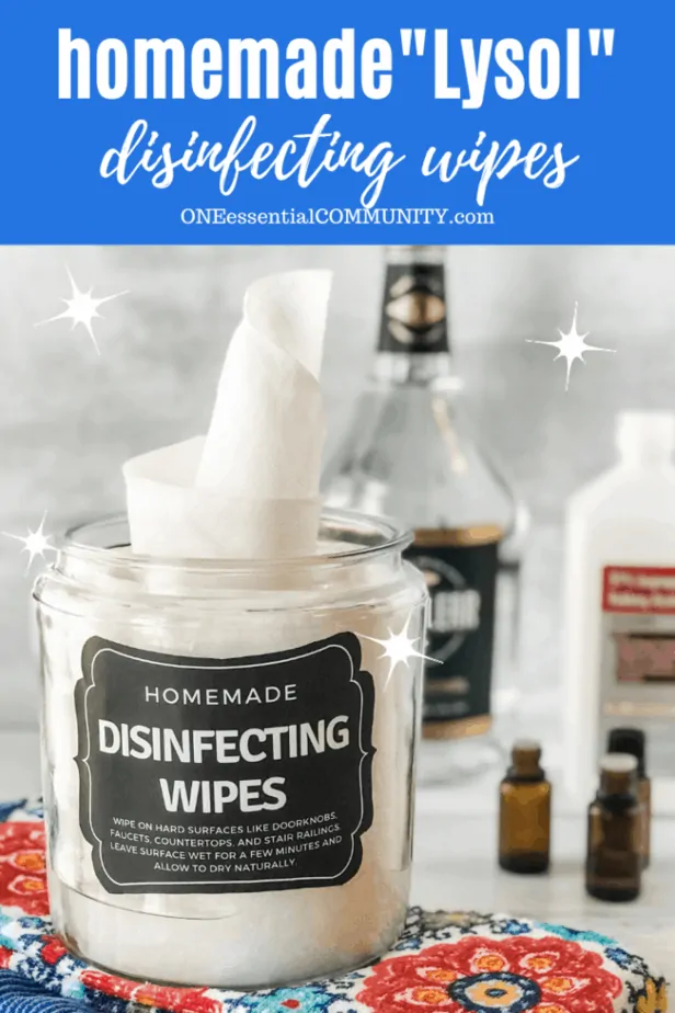 Homemade "Lysol" disinfecting wipes in glass canister with alcohol and essential oils in background