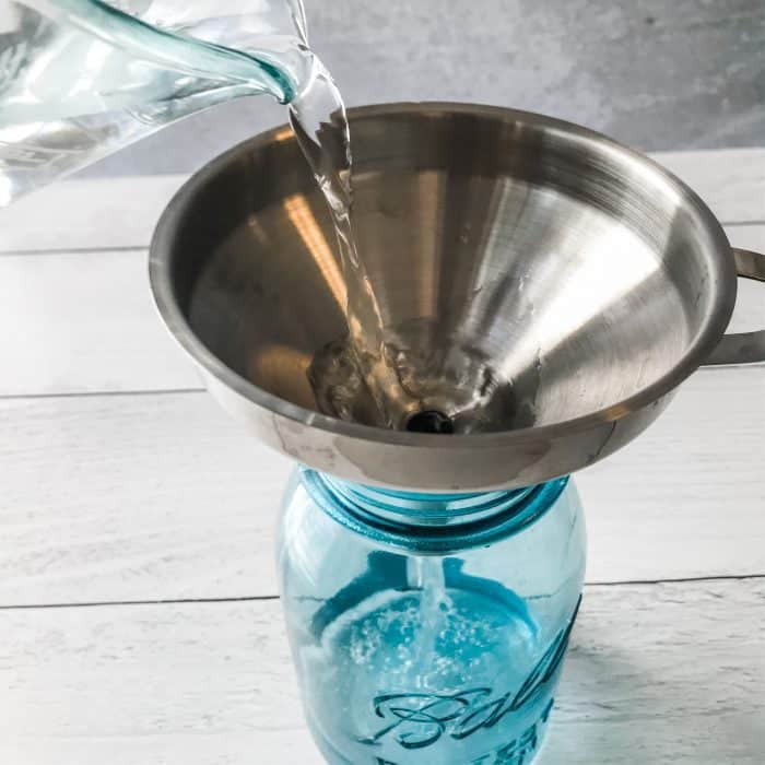 pouring water into spray bottle