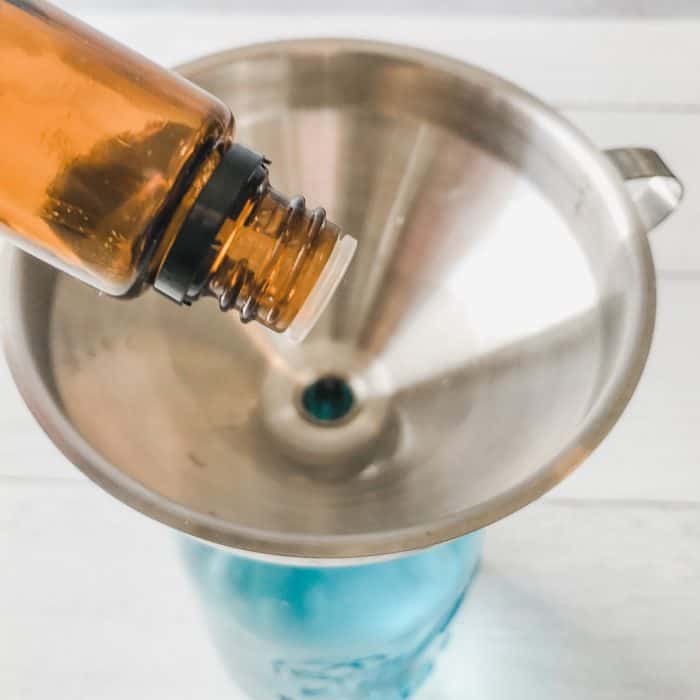 adding essential oil to homemade odor eliminator spray