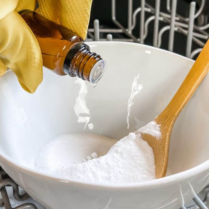 adding essential oil to bowl