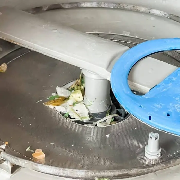 food and debris on bottom of dishwasher clogging the filter