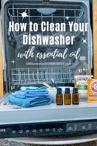 open dishwasher with cleaning supplies (essential oil, vinegar, baking soda)