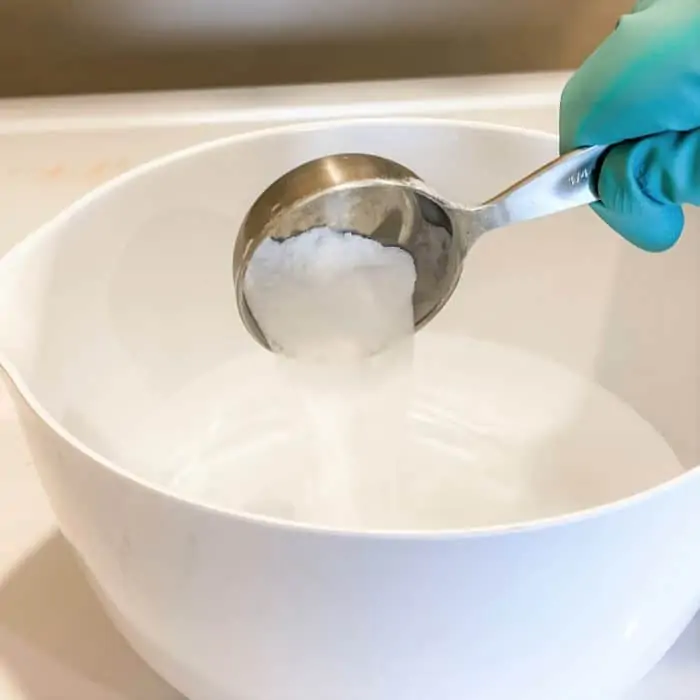 adding borax to bowl with homemade cleaner